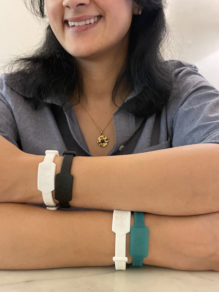 woman wearing two Tapr bands on each wrist.