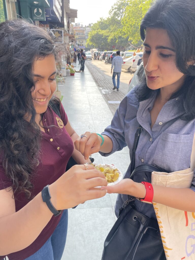 candid picture of two people eating chaat while wearing Tapr bands.