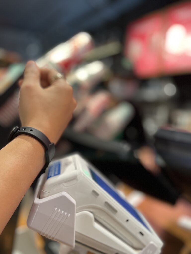 Wrist wearing Tapr band held against a payment terminal, to demonstrate how easily and quickly a payment can be made.